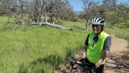 woman with bike on trail